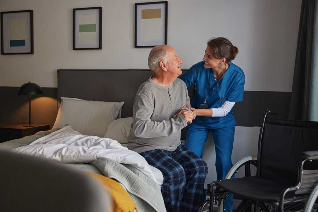 Two older adults and a younger family member arranging personal items in a cozy bedroom.